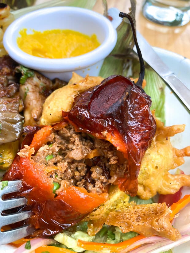 A stuffed red pepper cut open to show the vegetarian meat inside