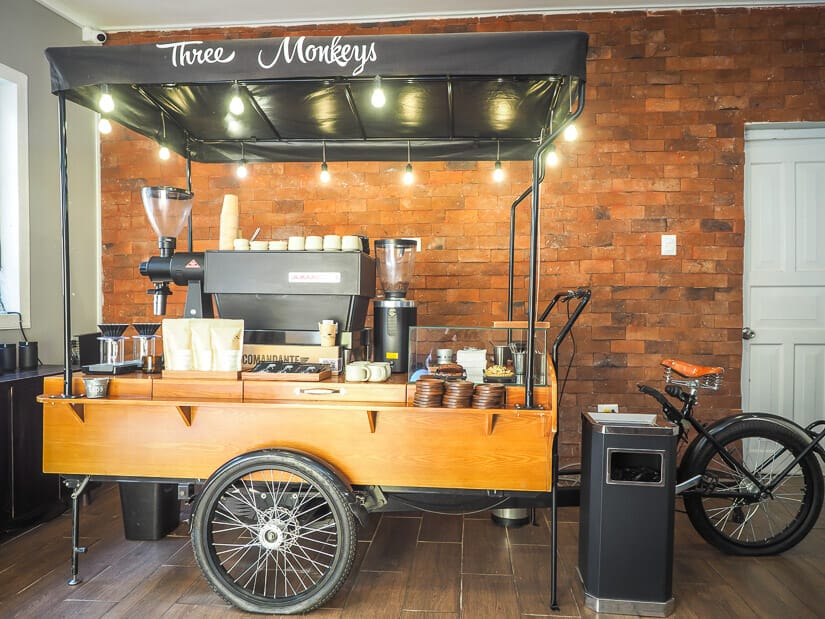 A bicycle coffee cart parked inside a cafe