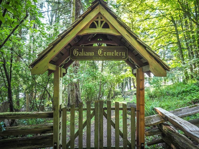 A wooden entrance gate that says "Galiano Cemetery" on it