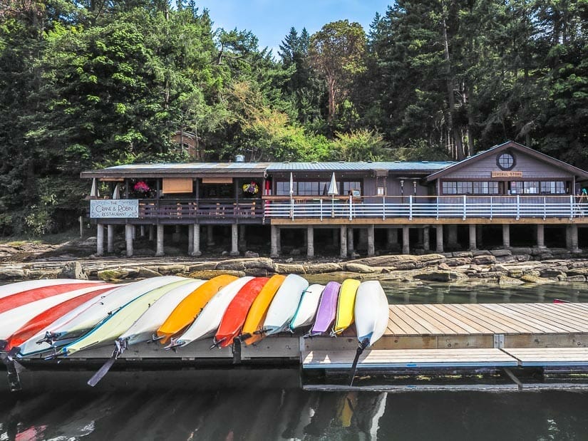 A row of colorful docks on a dock in front of a harbour building