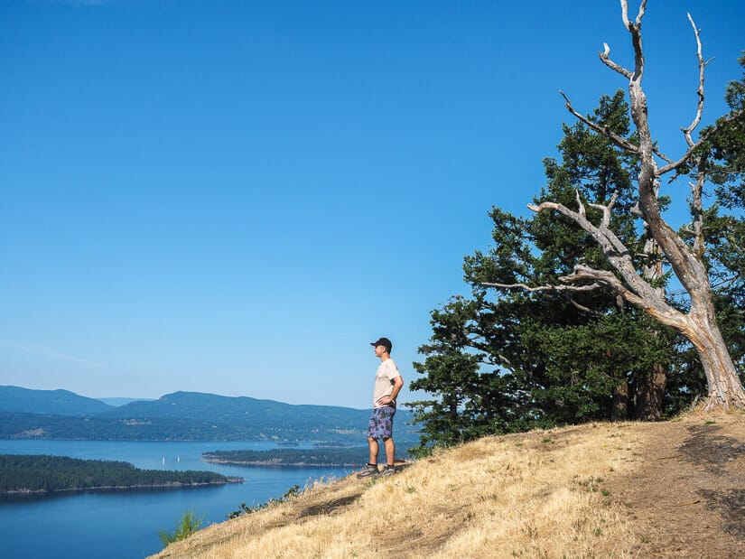 Nick Kembel standing on the peak of Mount Galiano overlooking islands in the distance