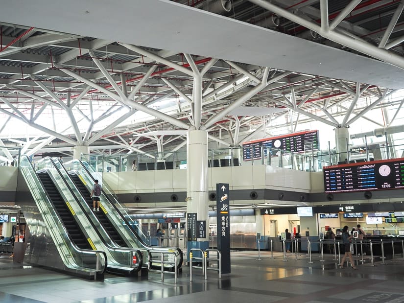 Inside a large High Speed Rail station in Taiwan, with escalators going up to a second floor
