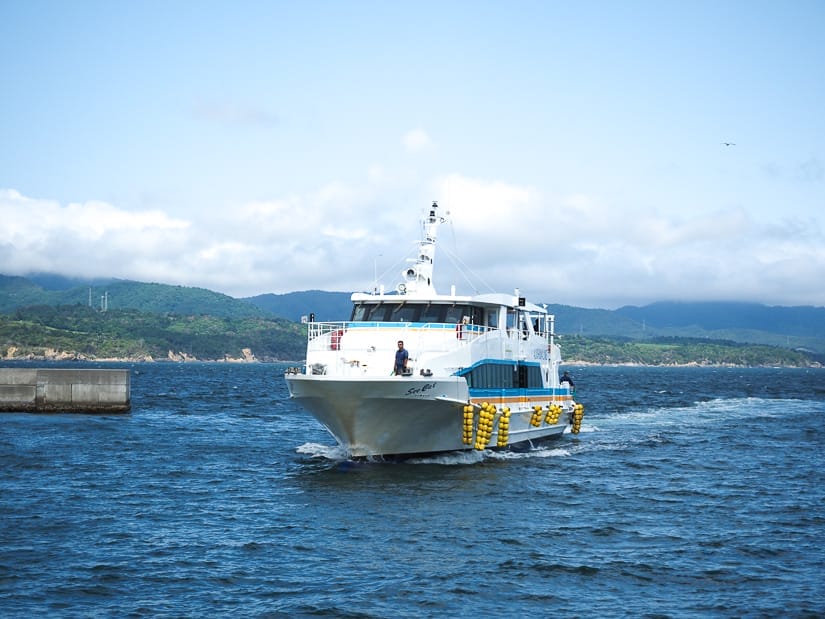 A small ferry coming in to port