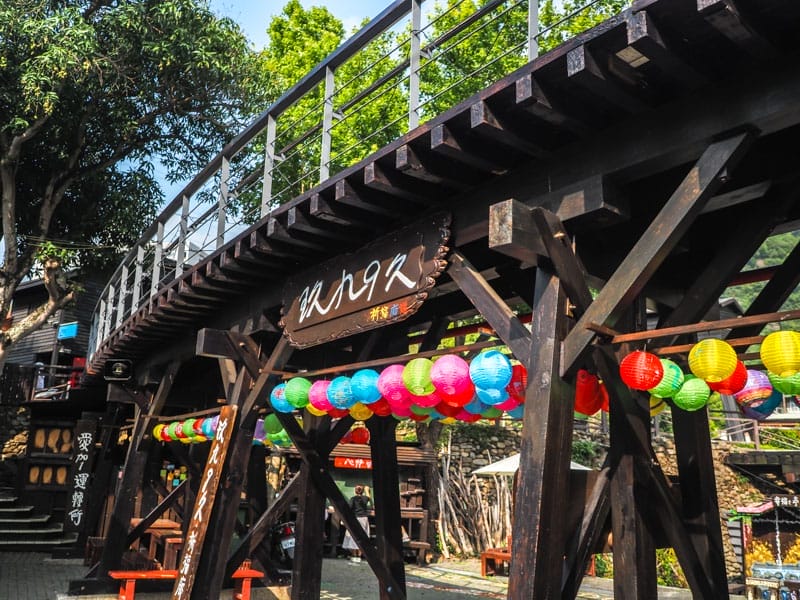 An old wooden railway bridge and lanterns on Checheng Old Street