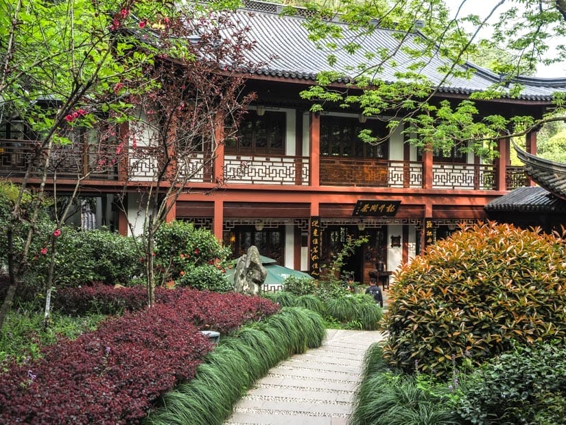 A path leading pst manicured gardens to a temple-like building