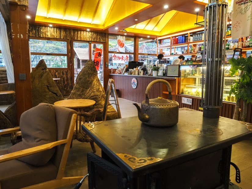 Inside a cafe with a tea pot on a traditional stove and the ordering counter behind